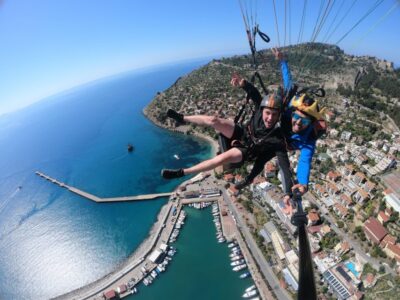 Tandem Paragliding Over a Castle and the Sea