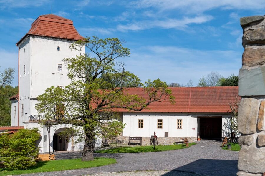 Ostrava: Entrance to Silesian Ostrava Castle - Green grounds, courtyard seating, and the amphitheater