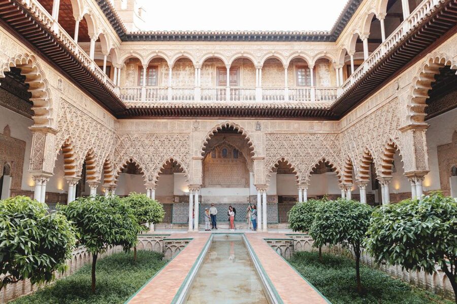 Seville: Guided Walking Tour with Alcazar & Cathedral Access - Walking through medieval Santa Cruz